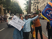 Lukho Maqashu with friends and school pupil Mujahida, 14, who got to miss school for the parade. Maqashu was dancing in the streets, amusing waiting fans by telling them the Boks had just called and told him they were on their way