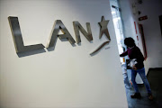 The logo of LAN Airlines, now known as LATAM Airlines, is seen at its office in Caracas, Venezuela. REUTERS/Carlos Garcia Rawlins