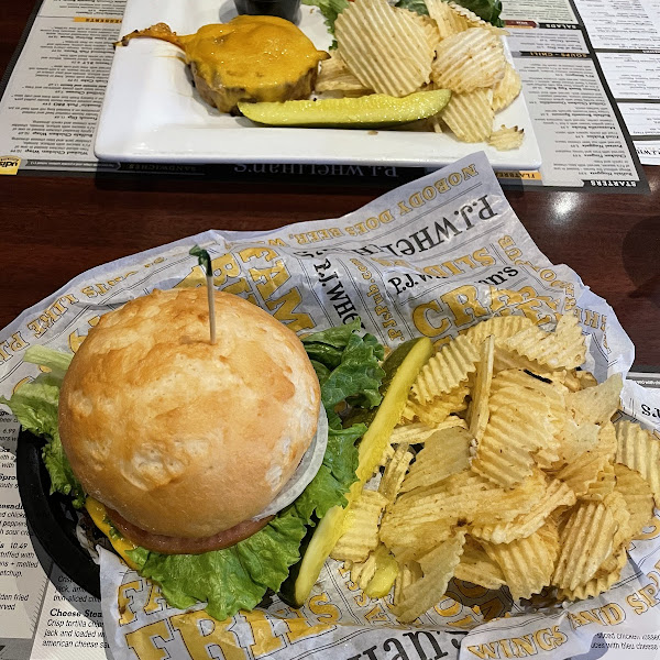 Cheeseburger with an UDI's bun, chips, and a pickle