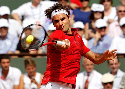 Roger Federer of Switzerland hits a forehand during the men's singles final match between Rafael Nadal of Spain and Roger Federer of Switzerland on day fifteen of the French Open at Roland Garros on June 5, 2011 in Paris, France