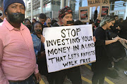 Protesters outside the Cape Town International Convention Centre, which is hosting the World Economic Forum Africa, on September 4 2019.