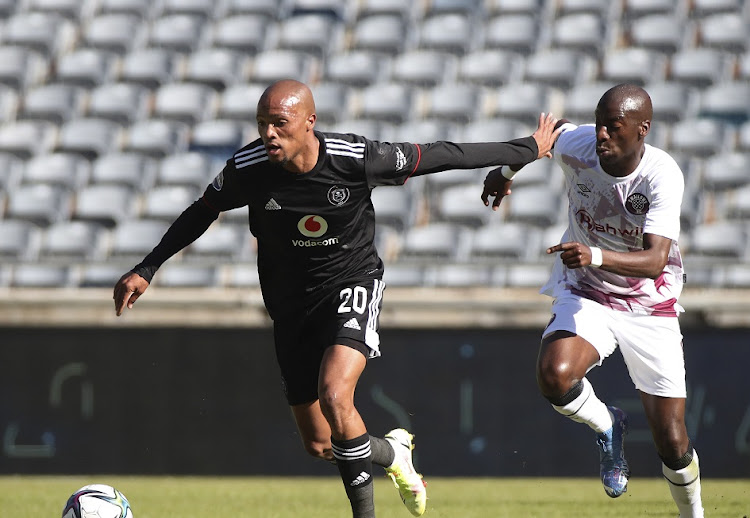 Goodman Mosele of Orlando Pirates is challenged by Musa Nyatama of Swallows FC in the DStv Premiership match at Orlando Stadium on September 11 2021.