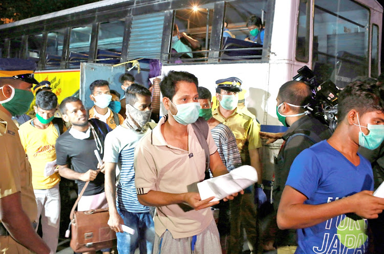 Migrant workers, who were stranded in the southern state of Kerala due to a lockdown imposed by the government to prevent the spread of Covid-19, arrive at a railway station to leave for their home state of eastern Odisha, in Kochi, India, on May 1, 2020.