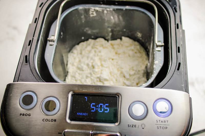 Dough Ingredients Added To A Bread Maker.