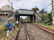 Commuters take chances as they race to the station to catch the next train.