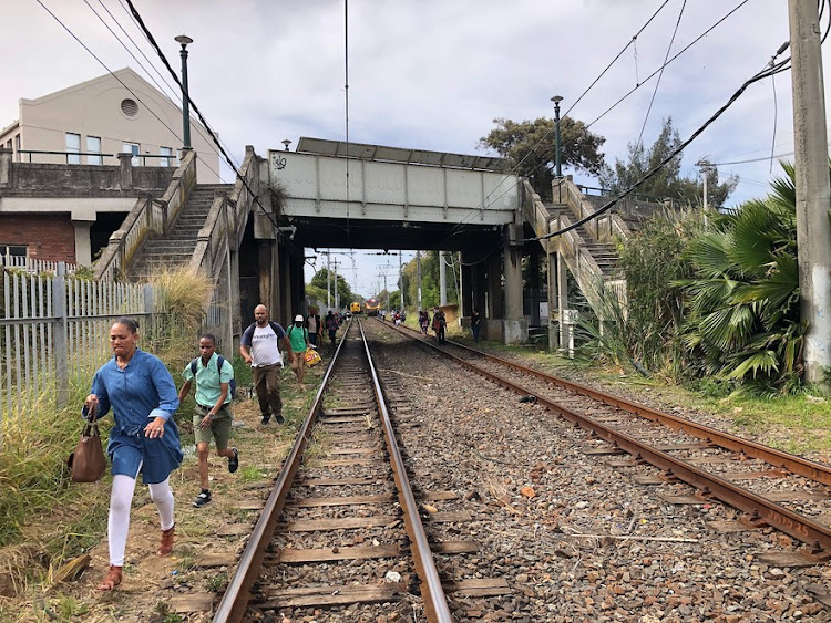 Commuters take chances as they race to the station to catch the next train.