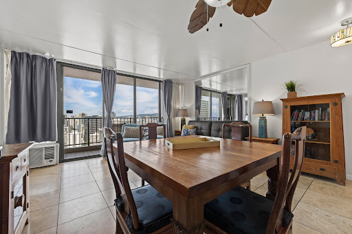 Dining room with open urban view in this luxury apartment / penthouse for sale in Honolulu ($849,000)