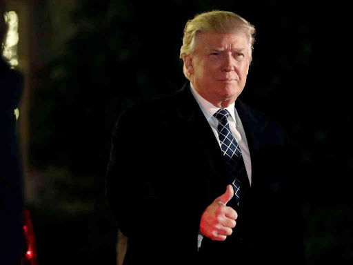 US President-elect Donald Trump gives a thumbs up to the media as he arrives at a costume party at the home of hedge fund billionaire and campaign donor Robert Mercer in Head of the Harbor, New York, December 3, 2016. /REUTERS