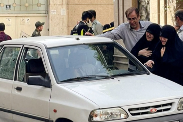 Family members of Colonel Sayad Khodai, a member of Iran's Islamic Revolution Guards Corps, weep over his body in his car after he was reportedly shot by two assailants in Tehran, Iran, May 22, 2022.