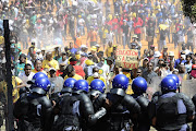 University students march on the Union Buildings on October 23 as part of a nationwide protest against a tuition fee increase and to demand that tertiary education be free. Police fired rubber bullets to disperse the crowd