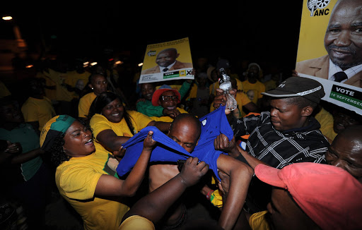 ANC supporters in Ikageng Township rip off the t-shirt of a DA supporter in Potchefstroom, South Africa. The DA claims it was attacked by ANC supporters in Pretoria on Friday 23 October 2015 while preparing for the launch of its Tshwane mayoral candidate Solly Msimanga's campaign.