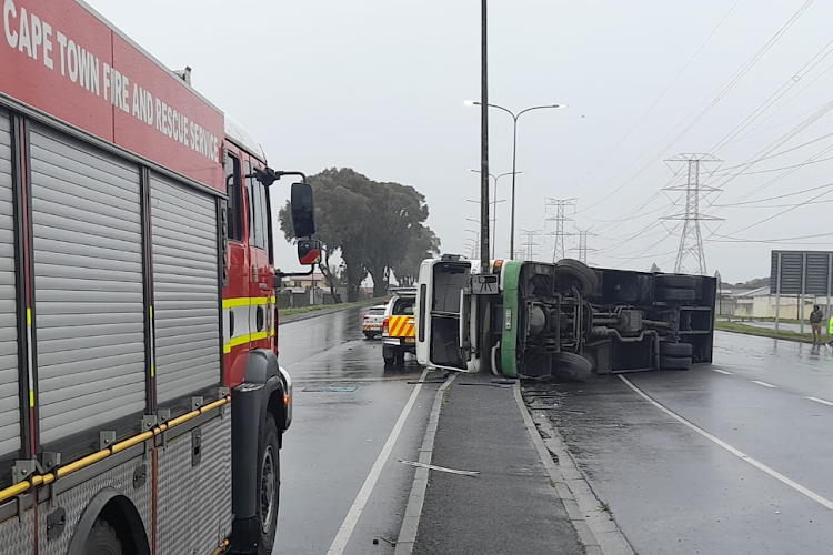 Three passengers died from their injuries when strong winds flipped a bus in Cape Town.