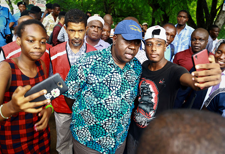 Interior CS Fred Matiang'i in a selfie with youths from Swahilipot Hub in Mombasa on Monday. Matiang'i was touring to see how youths are being helped.