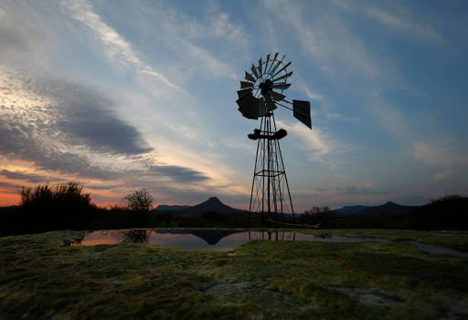 A windmill pumps water from a borehole near Graaf Reinet in the Karoo