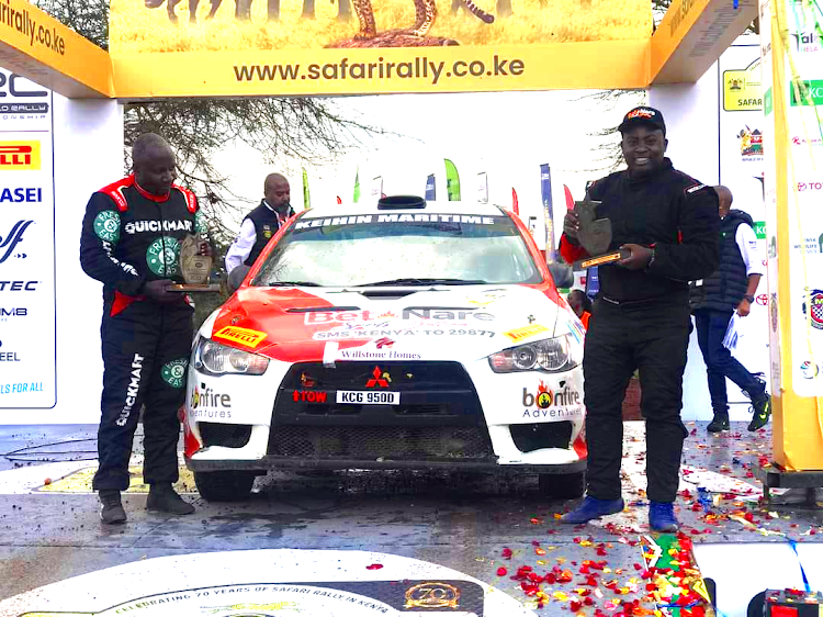 Issa Amwari (R) and his navigator Dennis Mwenda display their plaques during the WRC Safari Rally awards ceremony in Naivasha