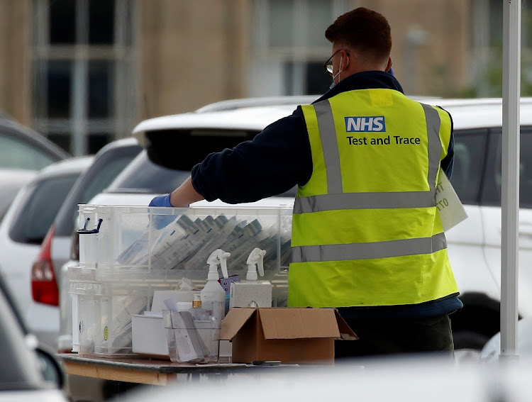 An NHS test and trace worker sorts through coronavirus (Covid-19) tests at a drive-through testing facility in Bolton, Britain, September 7, 2020.