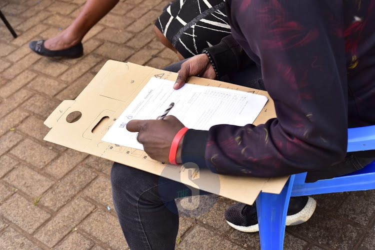 A donor fills a data form during a blood drive by the Kenya Tissue and Transplant Authority at Radio Africa on November 9, 2022.