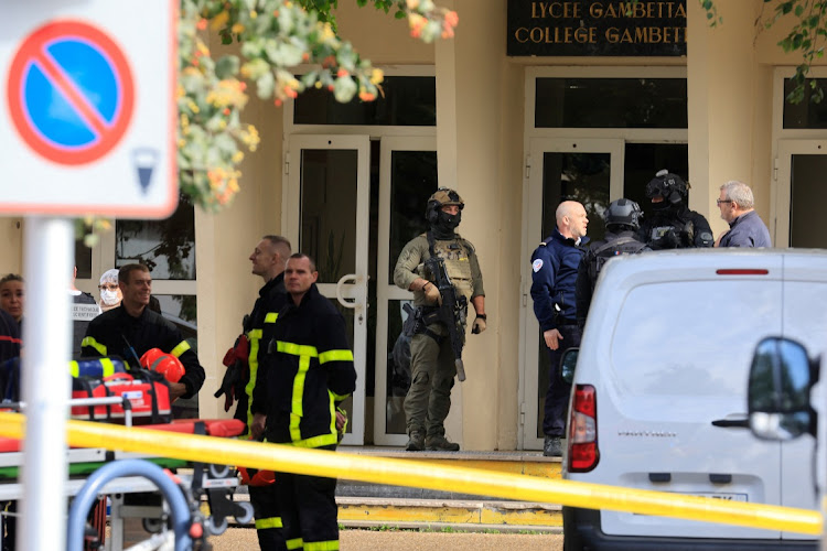 French police, soldiers and fire fighters work at the site after a teacher was killed and several people injured in a knife attack at the Lycee Gambetta-Carnot high school in Arras, northern France, October 13, 2023.