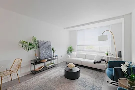 Modern, bright apartment living room with white sofa, plants, and stylish decor.