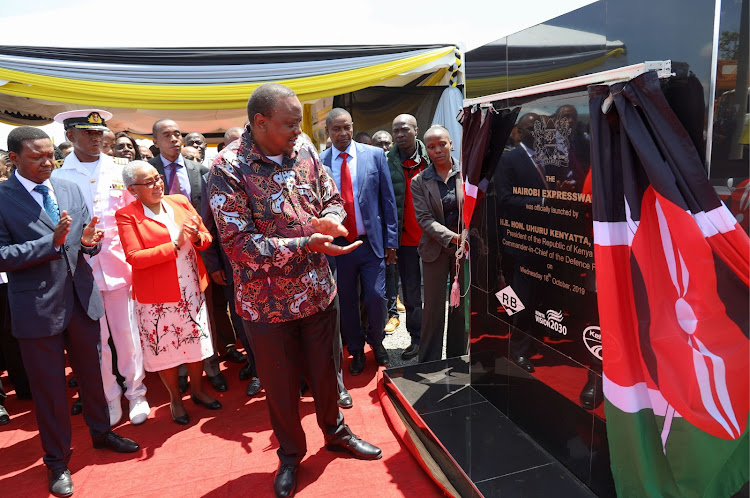 President Uhuru Kenyatta accompanied by First Lady Margaret Kenyatta unveils a commemorative plaque during the launch of construction of JKIA-Westlands Expressway, Nairobi