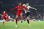 Harry Kane of Tottenham Hotspur battles for possession with Joel Matip of Liverpool in the Premier League match at Tottenham Hotspur Stadium on December 19 2021.