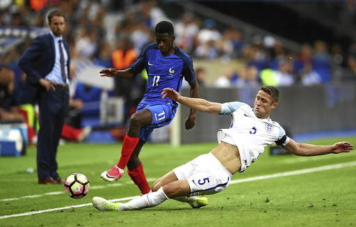 Ousmane Dembele of France is tackled by Gary Cahill of England in an international friendly in Paris last year. Cahill is ready to take on a lead role at the World Cup in Russia.