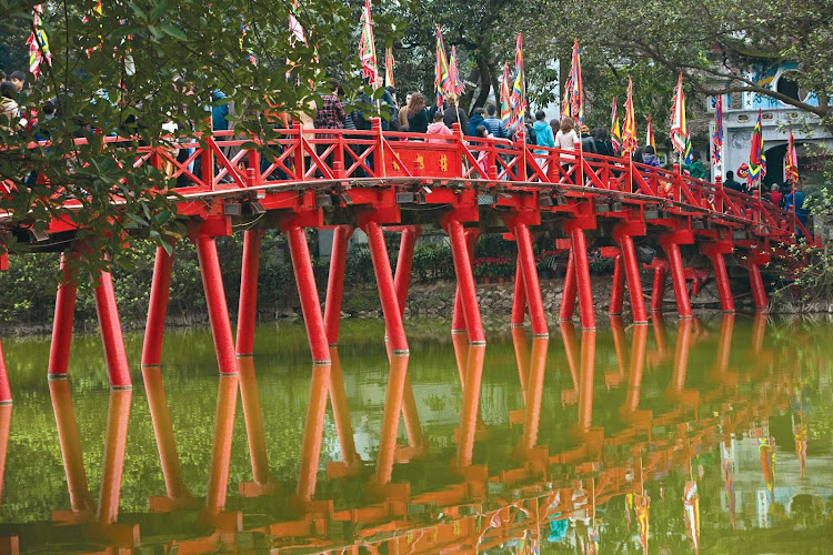  Locals cross a picturesque bridge in Hanoi, Vietnam, during a Uniworld cruise in River Orchid. 