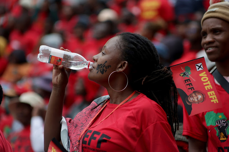 An EFF supporter drinks water during the party's election manifesto launch at Moses Mabhida Stadium in Durban on Saturday.