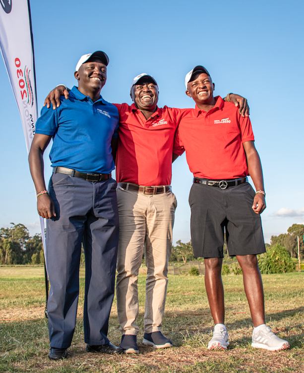 Professional Golfers of Kenya CJ Wangai (L) and Samuel Njoroge (R) pose for a photo during with Kenya Vision 2030 Director General Ken Mwige ahead of today's Kenya Open