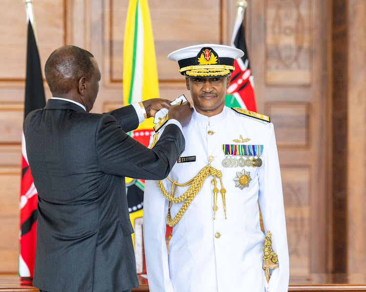 President William Ruto fits new insignia on Chief of Defence Forces General Charles Muriu Kahariri during the swearing in ceremony at State House, Nairobi, on May 3, 2024.