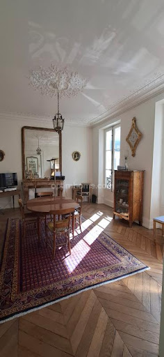 Dining room with parquet floor and Persian rug in this luxury apartment / penthouse for sale in Versailles ($921,783 - 98 m²)