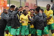 Bongokuhle Hlongwane of South Africa  celebrates scoring a goal with teammates during the 2022 FIFA World Cup Qualifier match between South Africa and Ghana at FNB Stadium on September 06, 2021 in Johannesburg, South Africa.