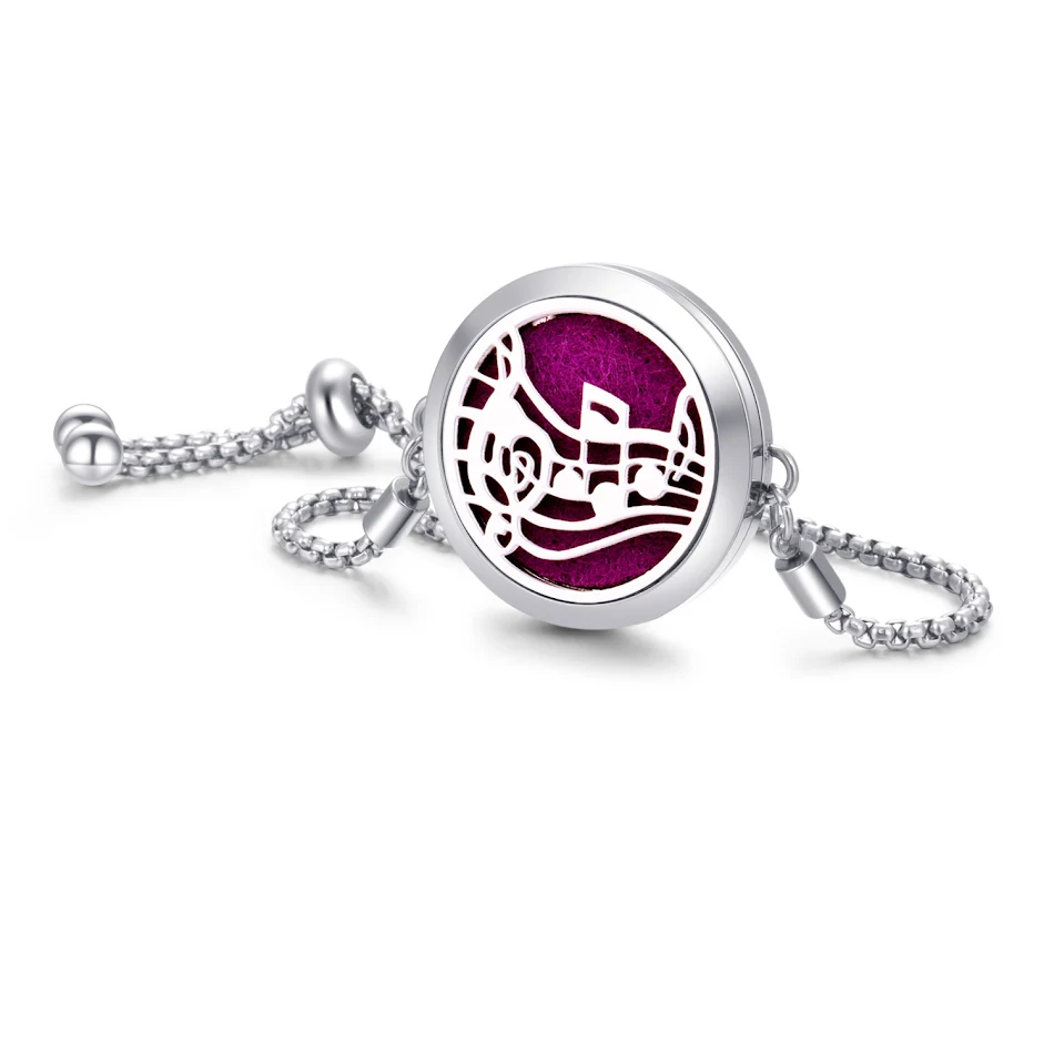 Bracelet vaporisateur ailes et notes de musique en alliage, un accessoire élégant qui parfume et orne votre poignet avec style et la mélodie.