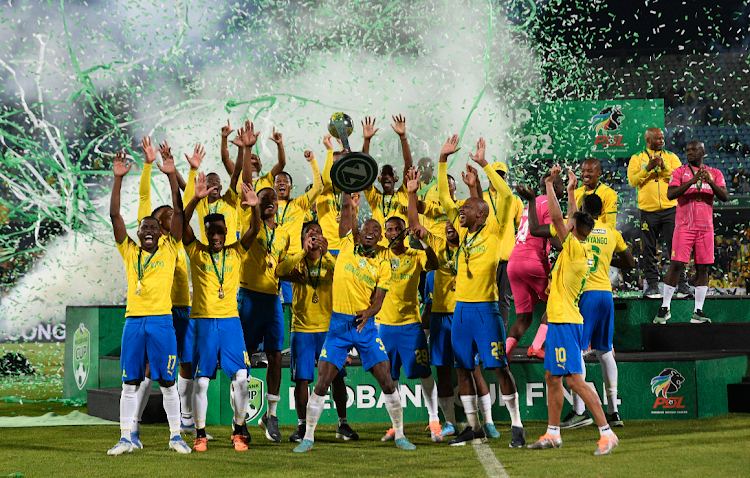 Mamelodi Sundowns players celebrates with the Nedbank Cup trophy after beating Marumo Gallants 2-1 after extra-time at the Royal Bafokeng Stadium on Saturday.