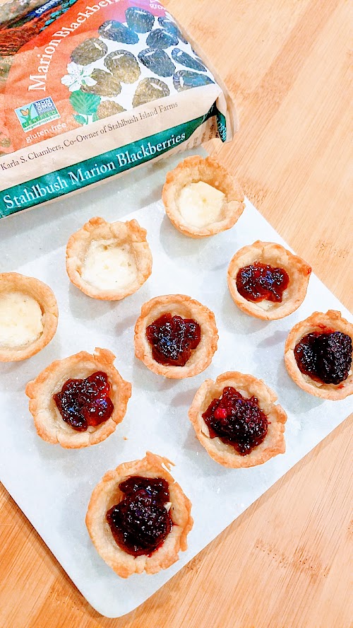 Berry Brie Bites, an easy recipe using only 4 ingredients, pie dough, brie, berry jam, and berry of your choice. Perfect for a party or potluck.