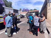 A group of people who identified themselves as military veterans outside the Kgosi Mampuru prison, where suspects are due to appear on charges related to the recent 'hostage' situation involving two cabinet ministers.