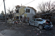 A house and car damaged during a Russian missile strike on Kyiv, Ukraine, on December 31 2022.