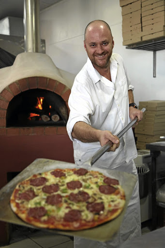 Milko Conte with a Pepperoni pizza at Caffè Italia.