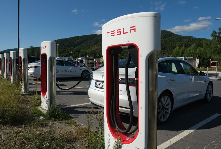 Tesla cars charge at a Tesla Supercharger charging station in Gulsvik, Norway.