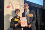 AmCham Taiwan Vice Chairperson Andrea Wu and President Andrew Wylegala pose with a copy of the 2022 White Paper by the American Chamber of Commerce in Taiwan, in Taipei, Taiwan June 22, 2022. 