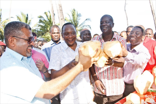 Cheers: Mvita MP Abdulswamad Nassir, President Uhuru Kenyatta and Kilifi North MP Gideon Mung’aro drink coconut water in Mombasa in September 2014. Mung’aro rebelled after he was dropped by Cord as National Assembly Minority Chief Whip.