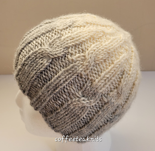 cream and tan cable knit hat on mannequin head