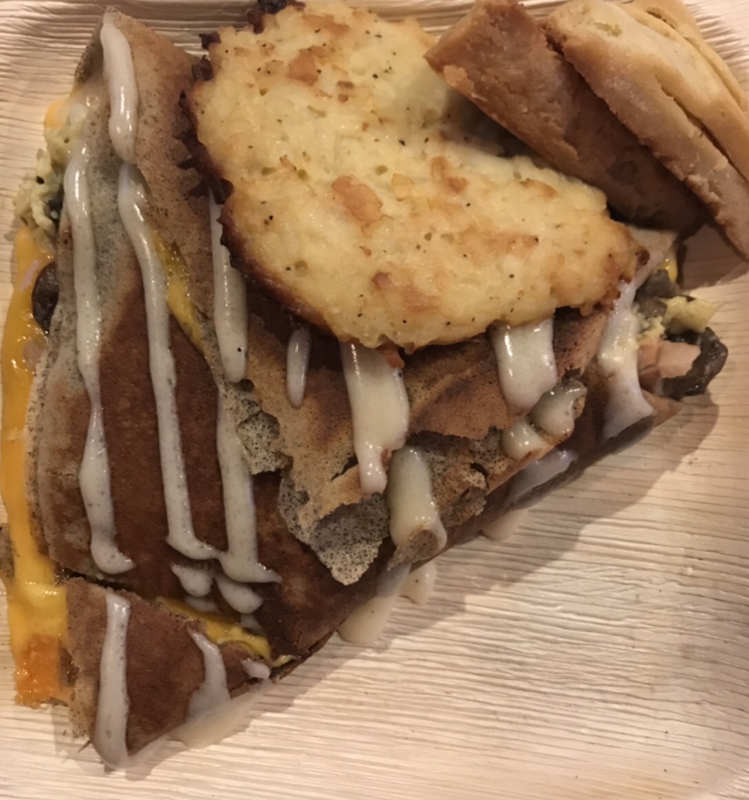 Crepe-Lette (turkey, cheddar cheese, mushroom, and onion omelette inside of a buckwheat crepe and drizzled with béchamel sauce.) Biscuits on the right. The Happy Tart.