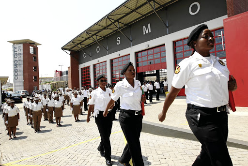 Dudu Ratlhogo, Neo Ramele and Tsholofelo Chilwaane of the public safety drill squad march during the opening of the Cosmo City fire station. /SANDILE NDLOVU