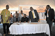 DEAL-MAKERS: Sekhukhune district mayor David Magabe, Limpopo agriculture MEC Jacob Marule and Greater Tubatse mayor Mahlake Nkosi (standing) sign a title deed.