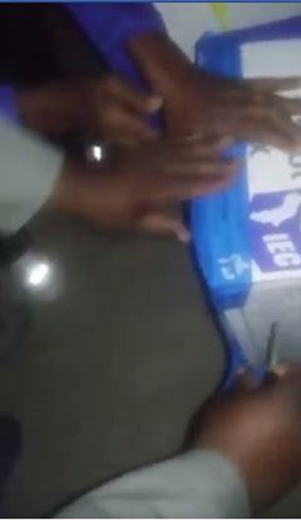 Screenshot of a ballot box being resealed by party agents who allegedly were suspecting that there was something sinister with the ballot box.