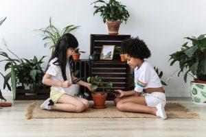 two girls taking care of the plant and learning about it