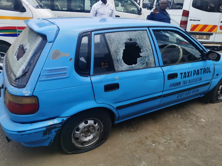 Security patrol car is said to have been shot at by police during a raid carried out on the taxi association's rank.