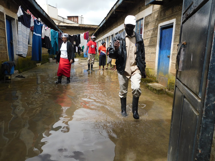 Tenants wade through flooded building in Ol Kalou town CBD