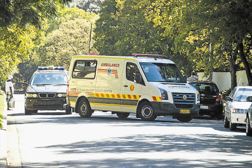 The ambulance carrying former president Nelson Mandela arrives at his home in Houghton, Johannesburg, yesterday after he spent nine days in hospital